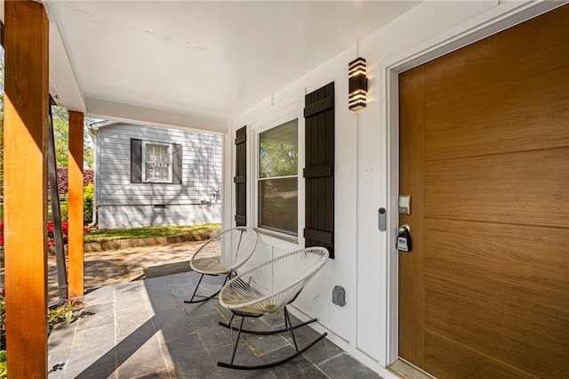 view of exterior entry featuring a porch
