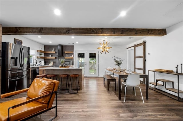 dining area with recessed lighting, french doors, a barn door, dark wood-type flooring, and beam ceiling