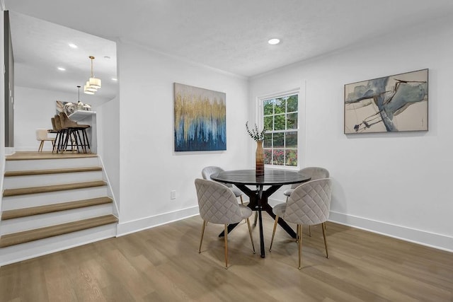 dining area featuring baseboards, recessed lighting, wood finished floors, and stairway