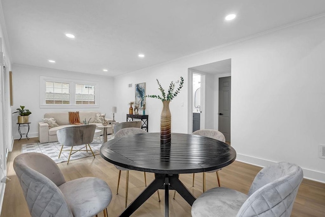 dining room with crown molding, visible vents, baseboards, recessed lighting, and wood finished floors