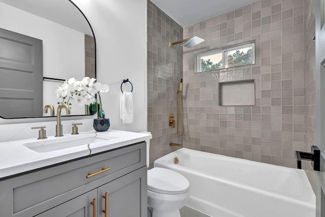 bathroom featuring bathing tub / shower combination, toilet, and vanity