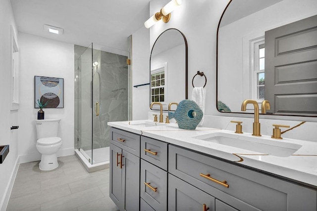full bath featuring toilet, a marble finish shower, a sink, and double vanity