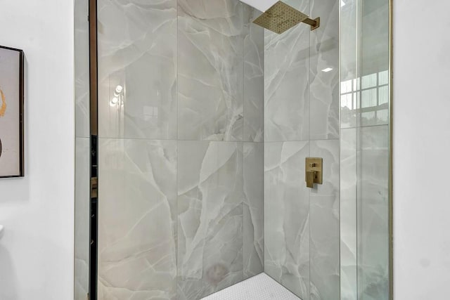 bathroom with a marble finish shower