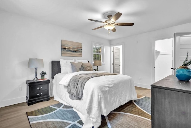 bedroom featuring ceiling fan, wood finished floors, and baseboards