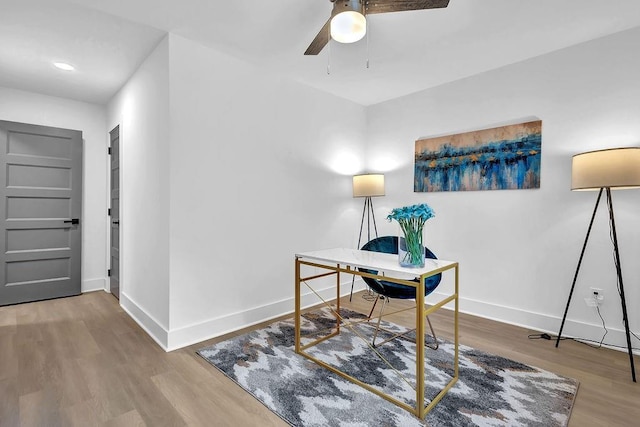 office area with ceiling fan, wood finished floors, and baseboards