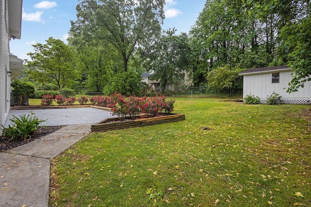 view of yard with fence and an outdoor structure