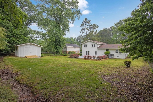 view of yard featuring an outbuilding, a storage unit, central AC unit, and fence