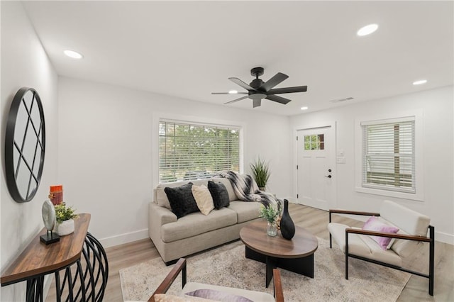 living room featuring ceiling fan and light hardwood / wood-style floors