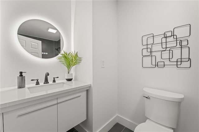 bathroom featuring tile patterned flooring, vanity, and toilet