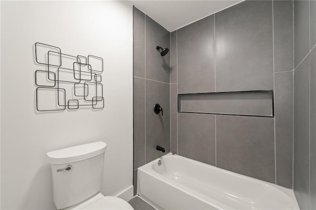 bathroom featuring tiled shower / bath and toilet