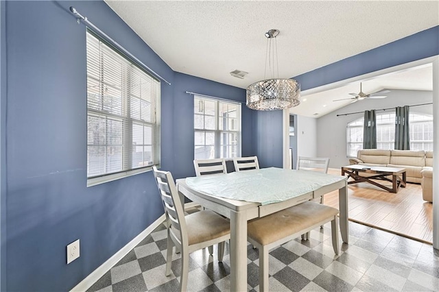 dining space featuring vaulted ceiling, a textured ceiling, visible vents, and baseboards