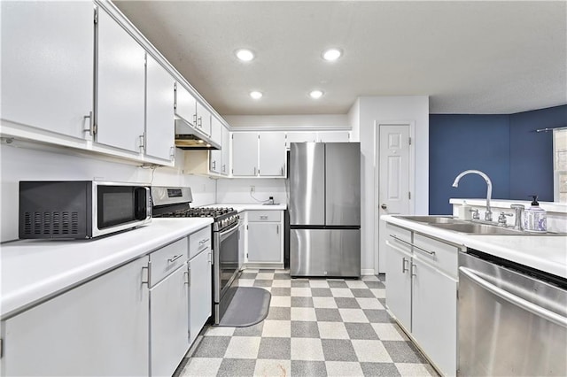 kitchen with light floors, stainless steel appliances, light countertops, a sink, and under cabinet range hood