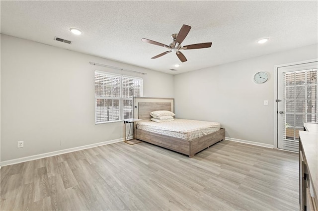 unfurnished bedroom featuring light wood-style floors, baseboards, access to exterior, and visible vents