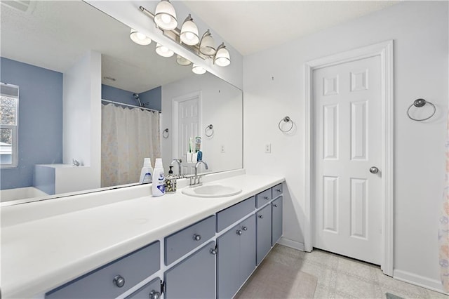 full bath with baseboards and vanity