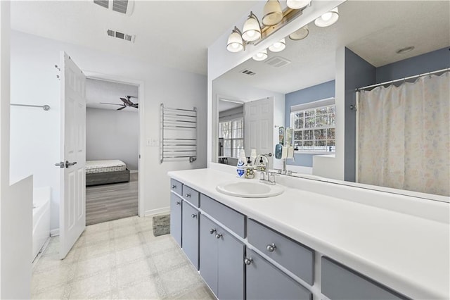 bathroom featuring visible vents, radiator heating unit, connected bathroom, vanity, and tile patterned floors