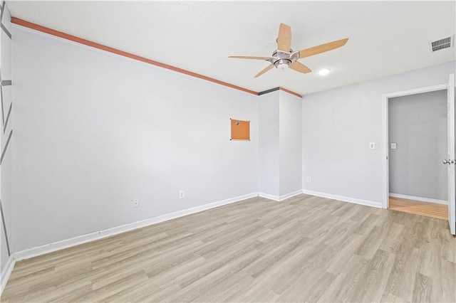 unfurnished room with light wood-style floors, visible vents, ceiling fan, and baseboards