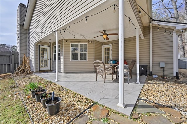 view of patio with a ceiling fan and fence