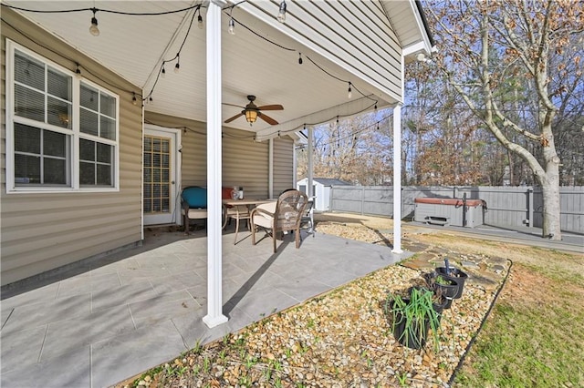 view of patio with a fenced backyard and a ceiling fan