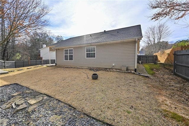 rear view of property with a fenced backyard