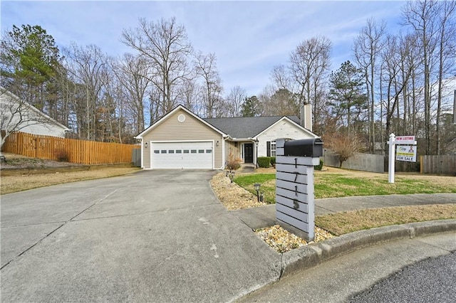 ranch-style house with driveway, a front lawn, an attached garage, and fence