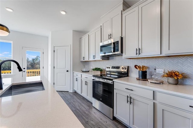 6121 Wayburn St, Tucker, GA 30084 - kitchen with appliances with stainless steel finishes, light countertops, tasteful backsplash, and recessed lighting