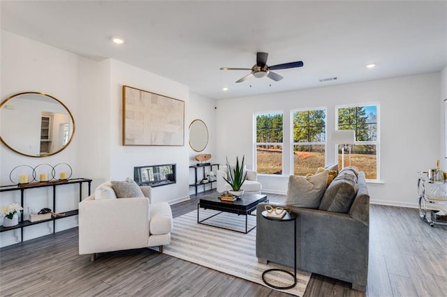 6121 Wayburn St, Tucker, GA 30084 - living room featuring a ceiling fan, wood finished floors, recessed lighting, and a glass covered fireplace