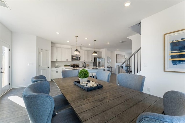 6121 Wayburn St, Tucker, GA 30084 - dining room featuring stairs, light wood-style flooring, and recessed lighting