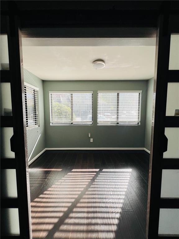unfurnished room featuring baseboards
