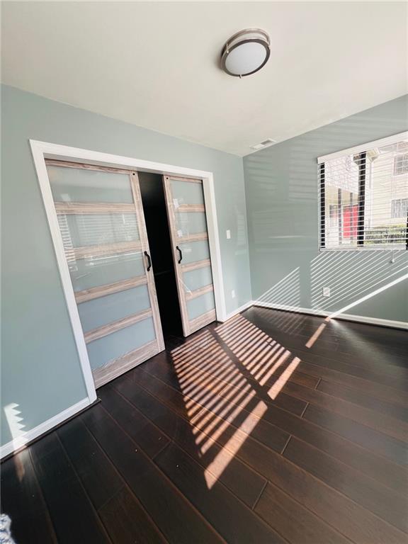 entrance foyer with baseboards and wood finished floors