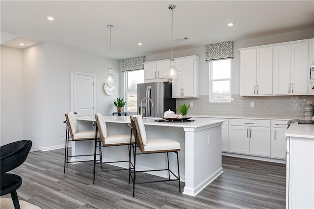 528 Aberdeen Mdw, Acworth, GA 30102 - kitchen with a center island with sink, dark wood-style floors, backsplash, and stainless steel refrigerator with ice dispenser
