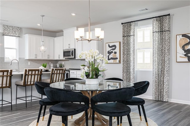 528 Aberdeen Mdw, Acworth, GA 30102 - dining space featuring recessed lighting, wood finished floors, visible vents, baseboards, and a notable chandelier