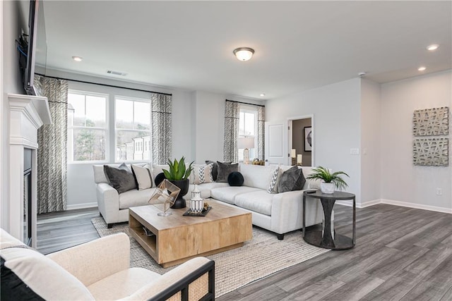 528 Aberdeen Mdw, Acworth, GA 30102 - living room with dark wood-type flooring, visible vents, baseboards, and a glass covered fireplace