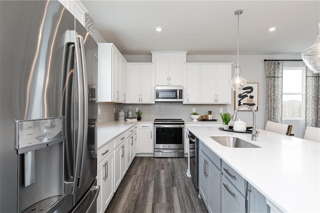 528 Aberdeen Mdw, Acworth, GA 30102 - kitchen with light countertops, white cabinetry, dark wood-type flooring, stainless steel appliances, and a sink