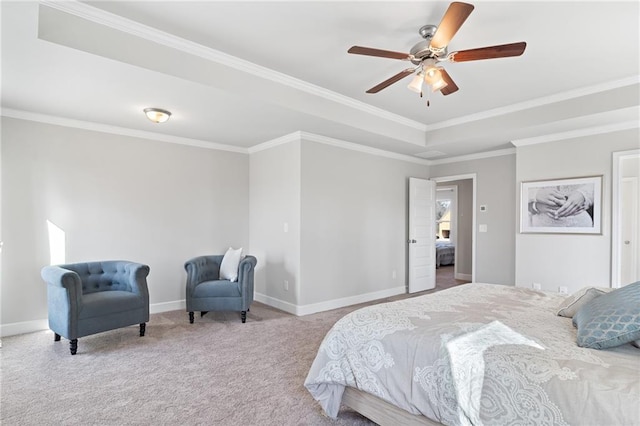 carpeted bedroom featuring ornamental molding, a tray ceiling, a ceiling fan, and baseboards