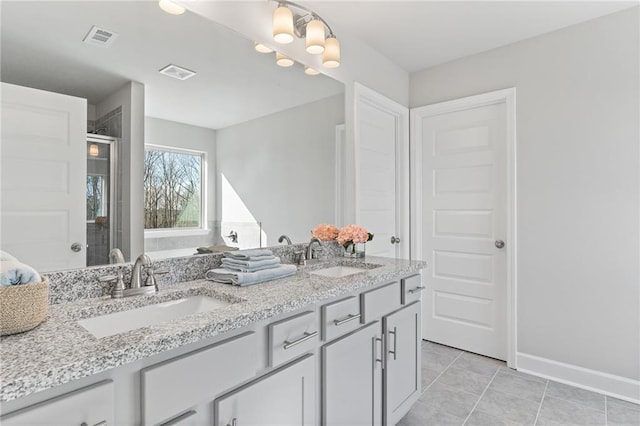 full bathroom featuring double vanity, a sink, and visible vents