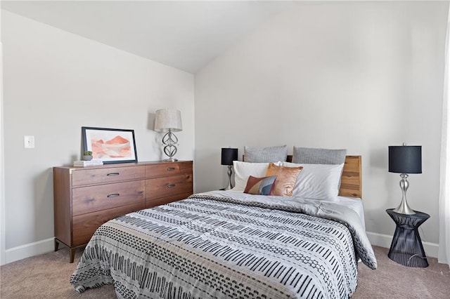 bedroom featuring light carpet, baseboards, and lofted ceiling