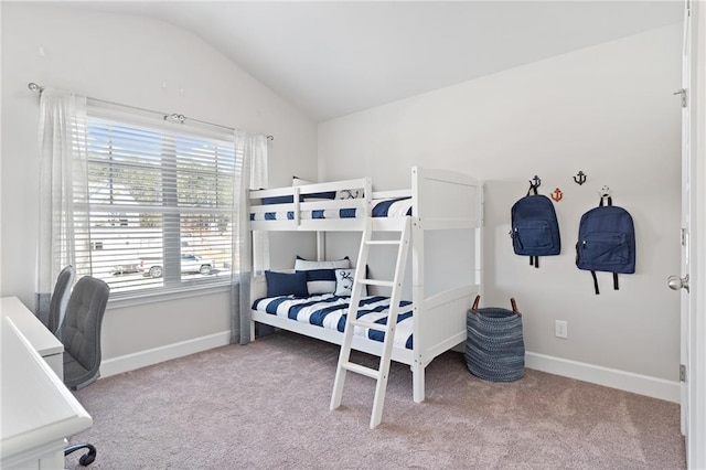 carpeted bedroom featuring baseboards and vaulted ceiling