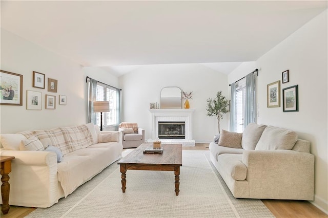 4086 Norton Pl SE, Smyrna, GA 30082 - living room with a fireplace, light wood-style flooring, baseboards, and vaulted ceiling