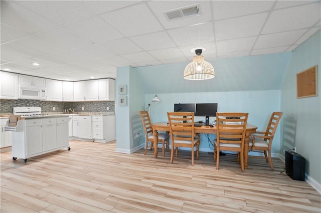 4086 Norton Pl SE, Smyrna, GA 30082 - dining room featuring visible vents, light wood-type flooring, baseboards, and lofted ceiling