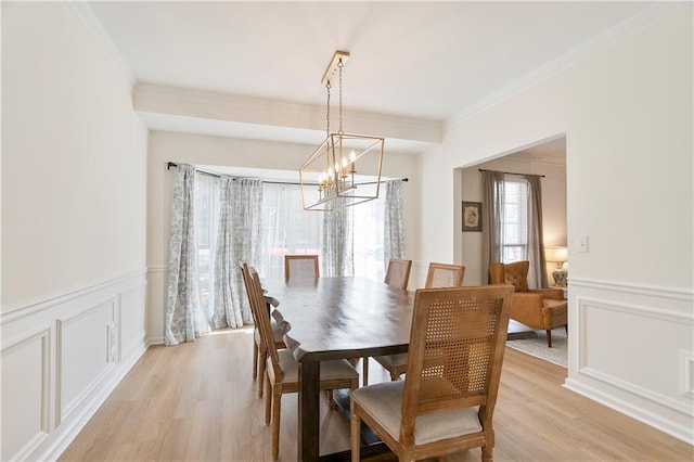 4086 Norton Pl SE, Smyrna, GA 30082 - dining area featuring a chandelier, light wood-type flooring, ornamental molding, and a wainscoted wall