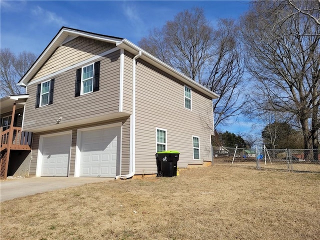 view of side of property with a garage and a lawn