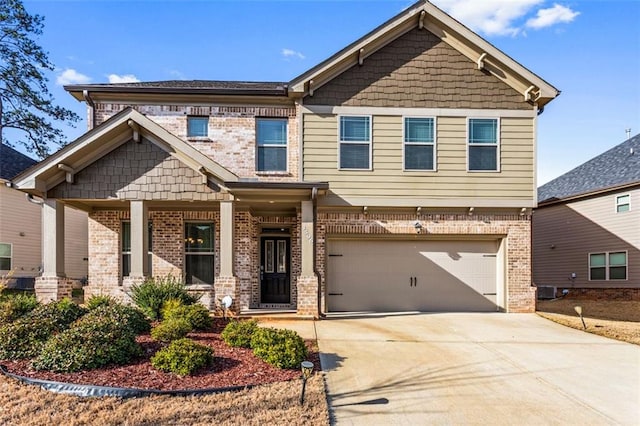 craftsman-style house featuring a garage, brick siding, cooling unit, and driveway