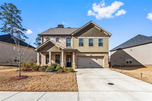 craftsman-style house featuring brick siding, an attached garage, central AC, and driveway