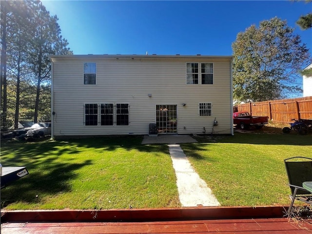 back of house with a lawn