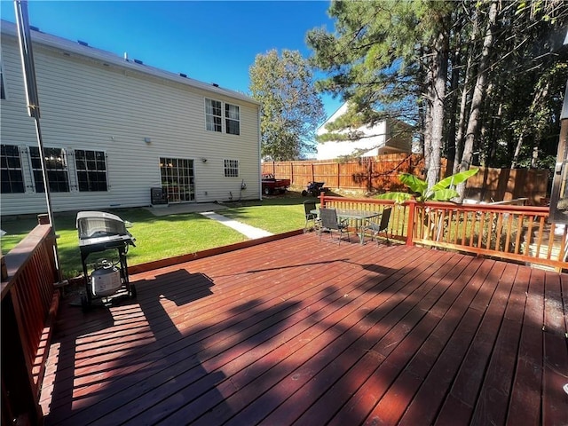 deck featuring a lawn and area for grilling