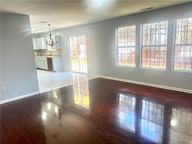 interior space featuring dark hardwood / wood-style floors, sink, and a chandelier