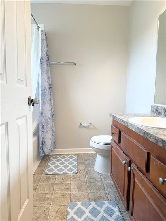602 Summer Pl, Norcross, GA 30071 - bathroom featuring vanity, toilet, baseboards, shower / bathtub combination with curtain, and stone finish flooring