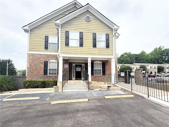 602 Summer Pl, Norcross, GA 30071 - townhome / multi-family property with uncovered parking, brick siding, and covered porch
