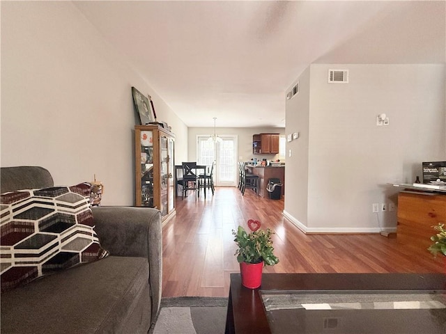 602 Summer Pl, Norcross, GA 30071 - living area with wood finished floors, a chandelier, and baseboards