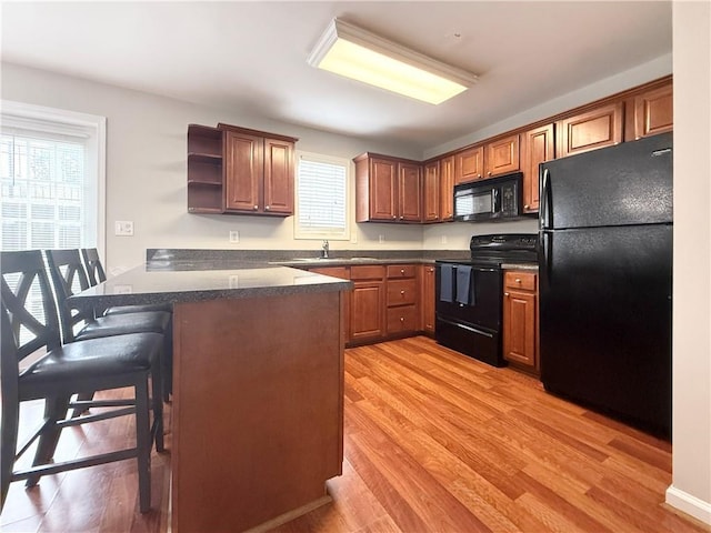 602 Summer Pl, Norcross, GA 30071 - kitchen featuring black appliances, a peninsula, open shelves, and light wood finished floors